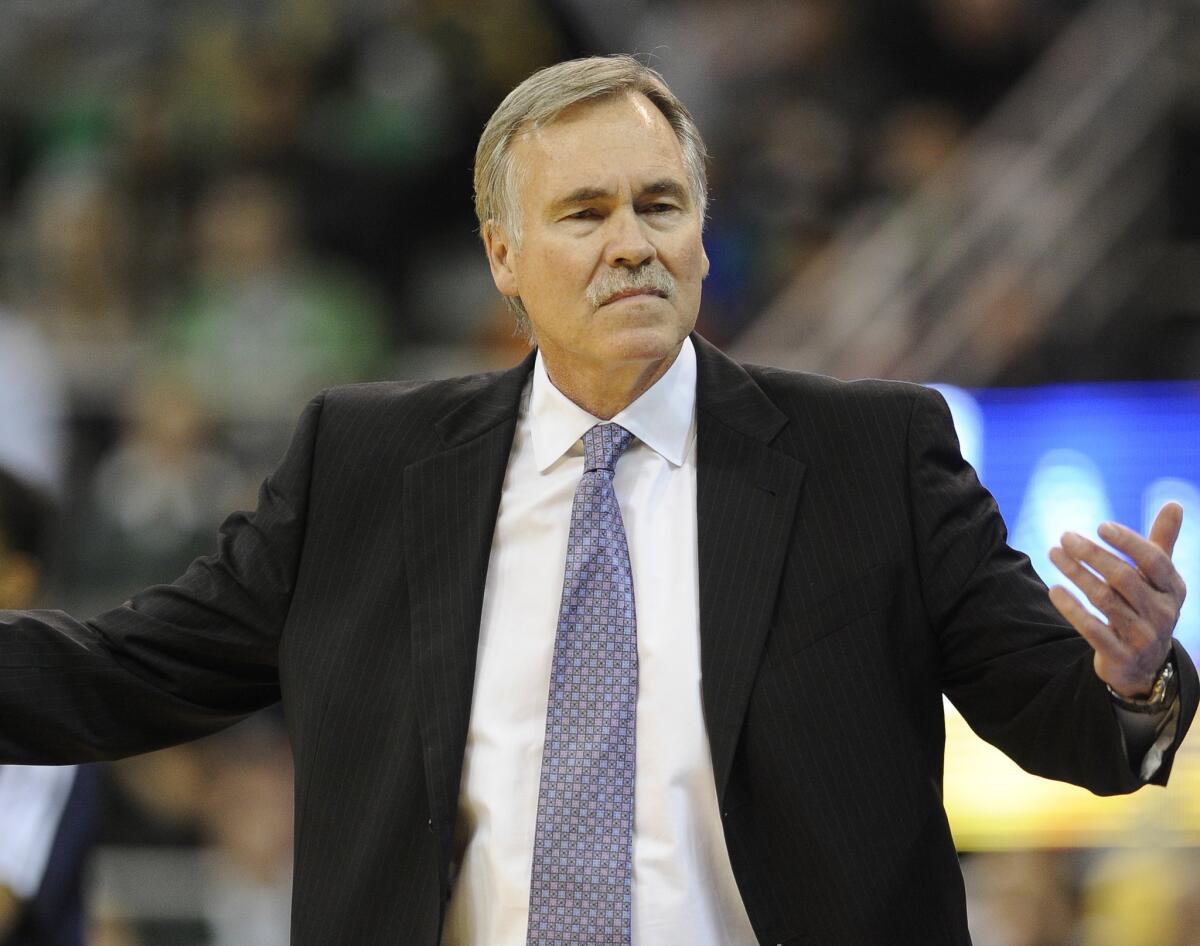 Lakers Coach Mike D'Antoni gestures to a referee during his team's 105-103 loss to the Utah Jazz on Friday. D'Antoni understands why ESPN has decided to drop coverage of the Lakers' upcoming game against the Houston Rockets.