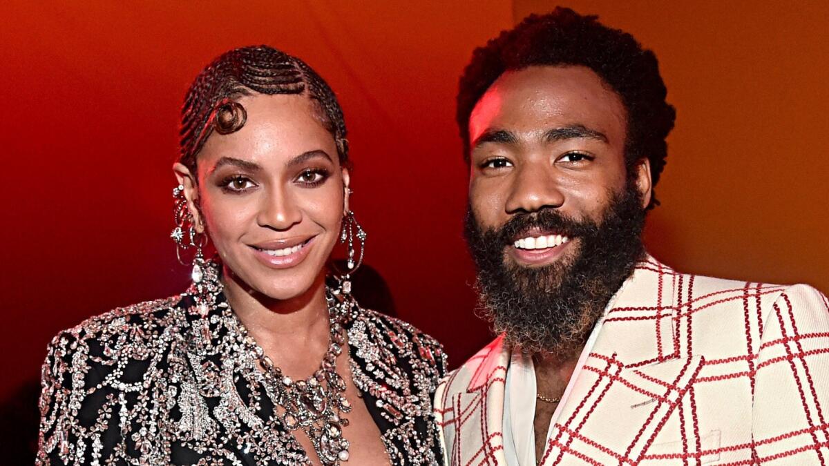 Beyoncé Knowles-Carter, left, and Donald Glover pose at the "Lion King" world premiere on Tuesday.