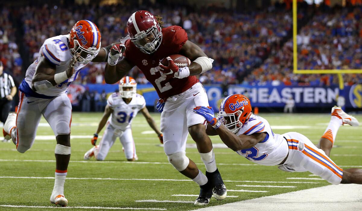 Alabama running back Derrick Henry (2) carries the ball against Florida linebacker Jarrad Davis (40) and defensive back Keanu Neal in the third quarter during the SEC Championship on Dec. 5.