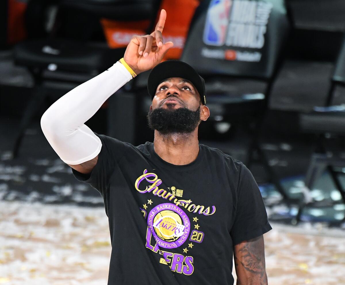 Lakers' LeBron James points to the sky after winning the NBA championship