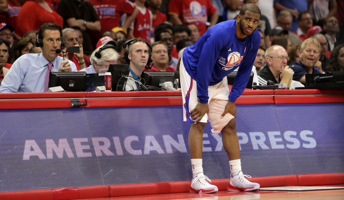Clippers point guard Chris Paul prepares to go back into Game 7 after injuring his left hamstring. The injury, though, has prevented him from playing in the second-round series against Houston.