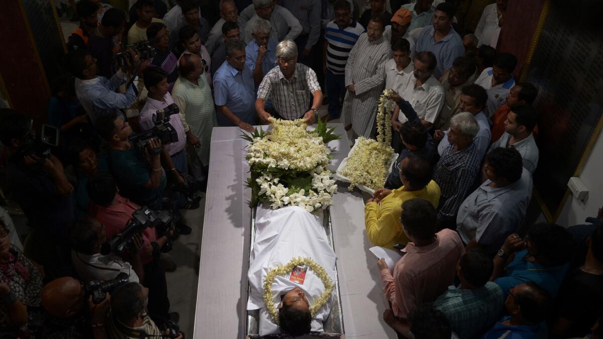 Mourners gather around the body of cricketer Ankit Keshri, 20, who died Monday after sustaining injuries during a cricket match in Kolkata, India, on Friday.