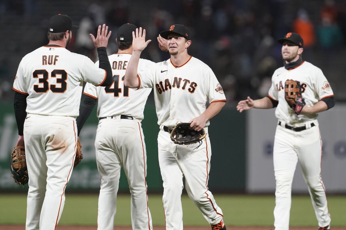 San Francisco Giants players celebrate after defeating the Miami Marlins on Thursday.
