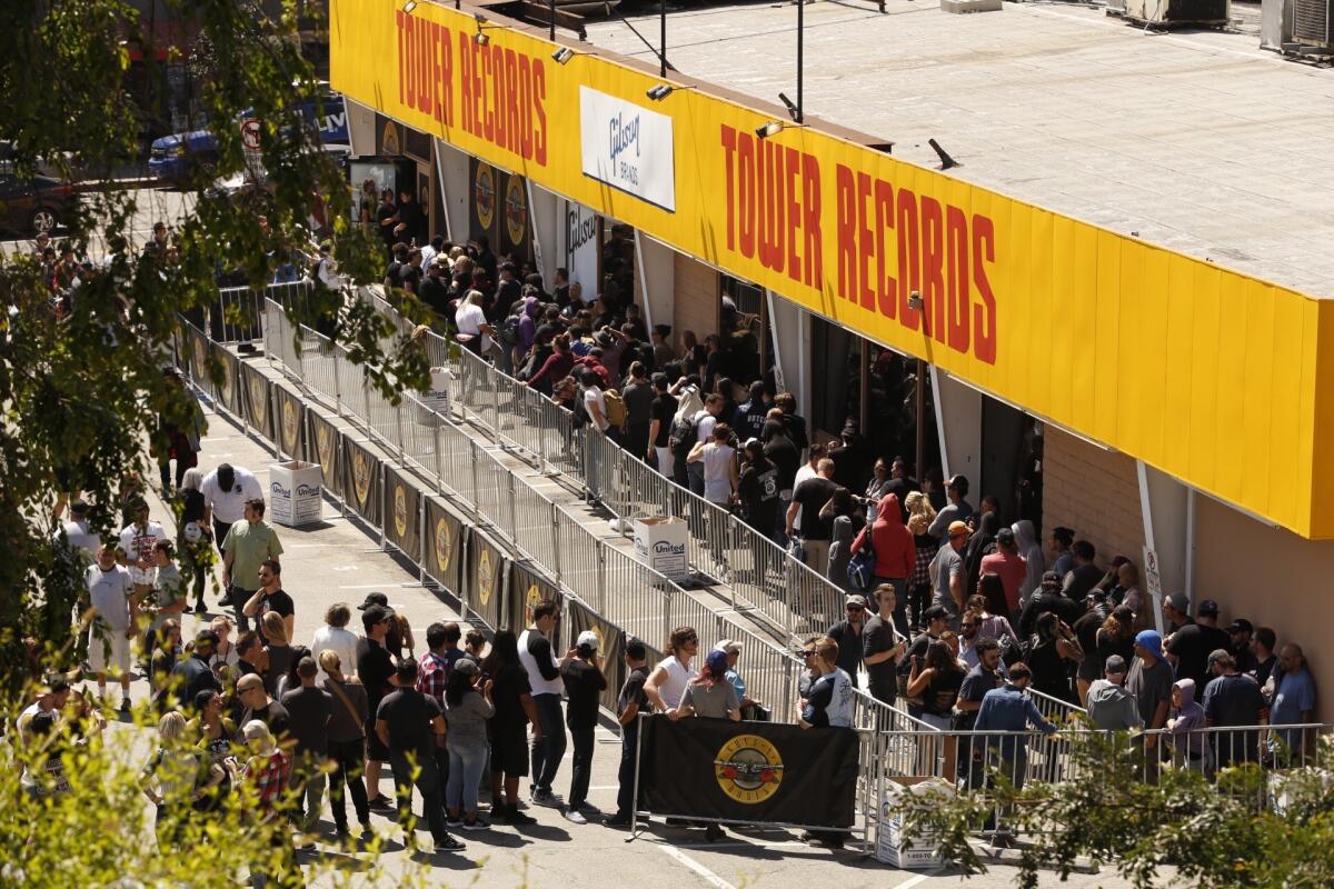 Guns N' Roses fans line up Friday morning at the former Tower Records store on Sunset Boulevard.