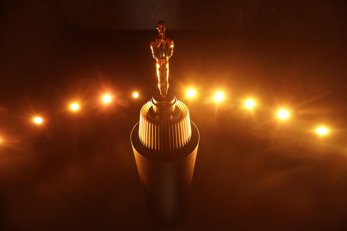An Oscar rests on a podium in The Oscar Experience at the Academy Museum of Motion Pictures.