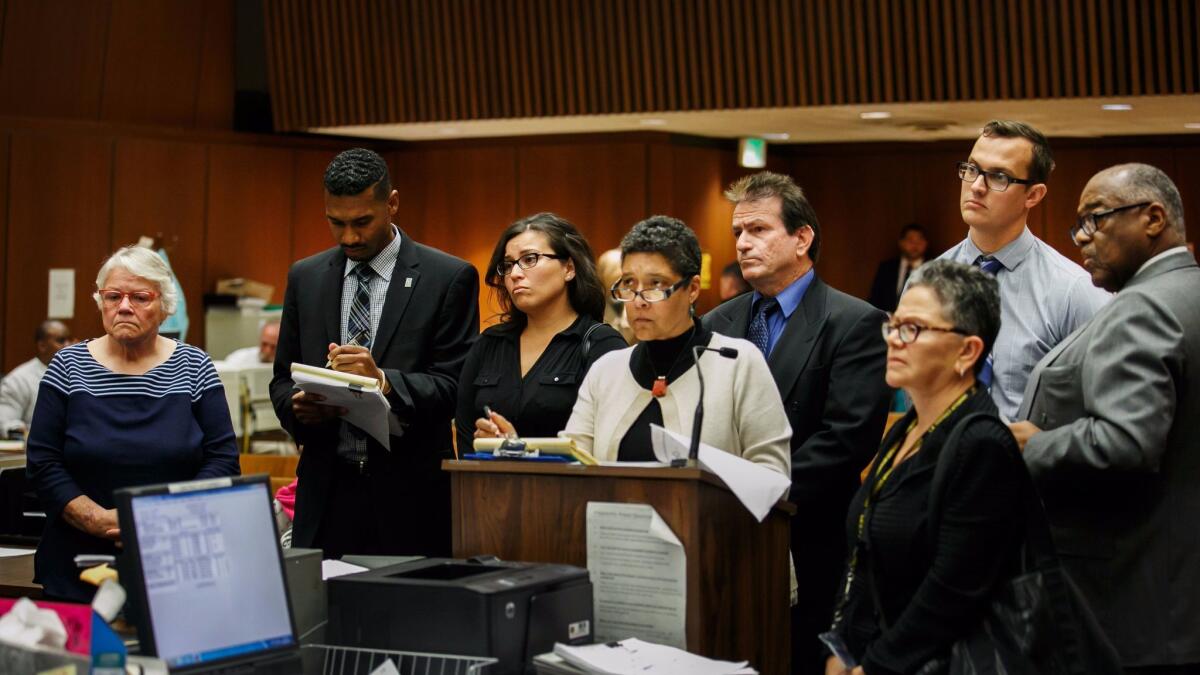 Social workers Stefanie Rodriguez, third from left, and Patricia Clement, far left, and supervisors Kevin Bom, second from right, and Gregory Merritt, fourth from right, appear for their arraignment.