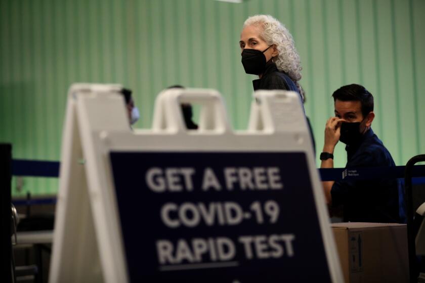 LOS ANGELES, CA - DECEMBER 3, 2021 - Dr. Barbara Ferrer, director of L.A. County Department of Health, visits a free COVID-19 Rapid Test site at the Tom Bradley International Terminal at Los Angeles International Airport Friday, December 3, 2021. This was the first day free tests were made available to arrivals and Dr. Ferrer personally tried to direct many travelers to take a free test. In partnership with the state and U.S. Centers for Disease Control and Prevention, the county set up a free rapid testing site for arriving passengers. They were also gave those testing negative a kit they can use to test themselves again three to five days later, in line with CDC recommendations for international travelers coming to the U.S., regardless of vaccination status. (Genaro Molina / Los Angeles Times)