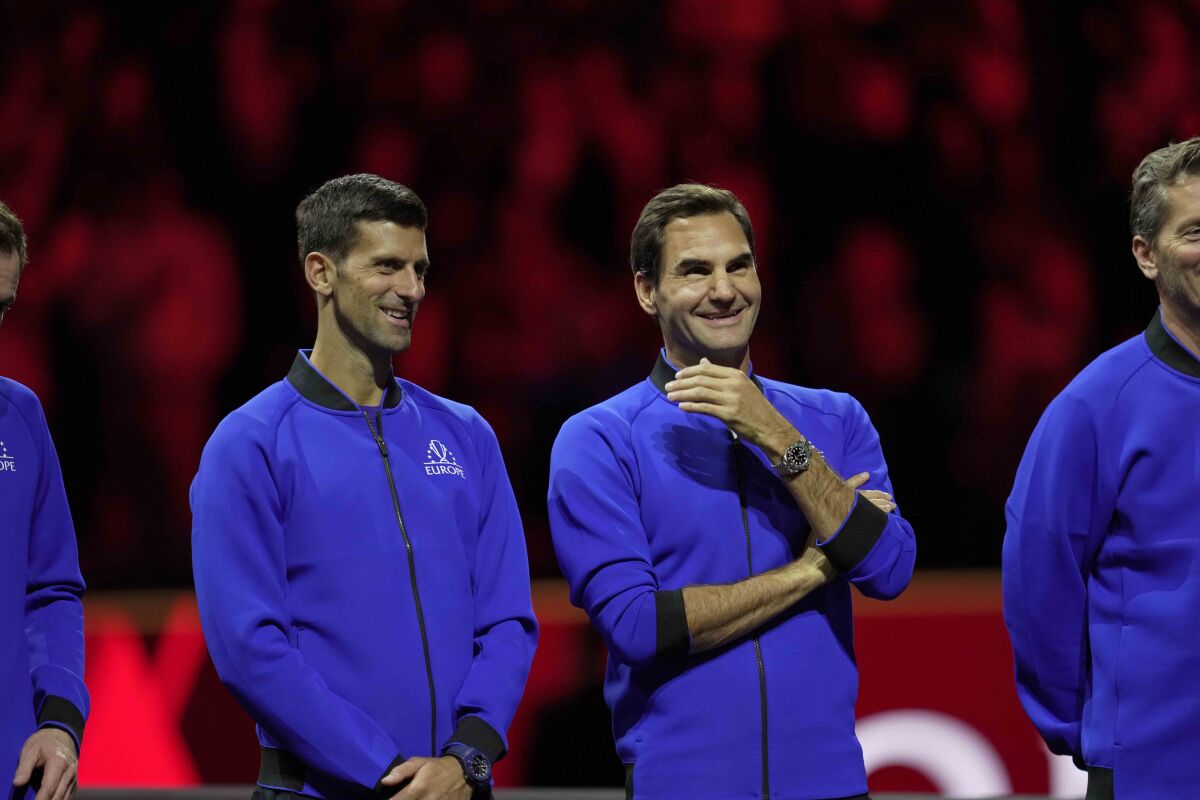 Team Europe's Novak Djokovic and Roger Federer stand side by side at the end of the Laver Cup tennis tournament in London, Sunday, Sept. 25, 2022. (AP Photo/Kin Cheung)