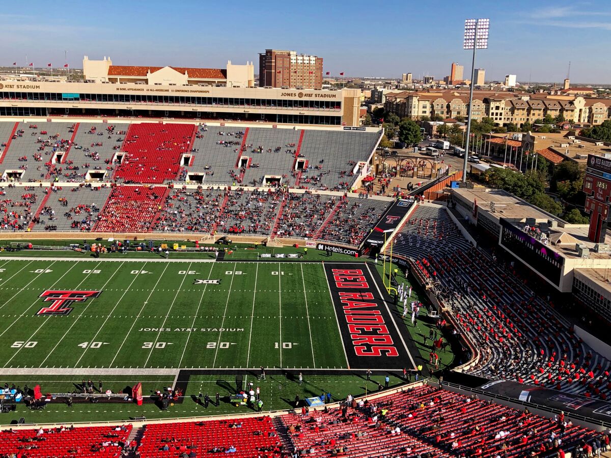 A press-box view of fans scattered throughout the seats of Texas Tech football stadium