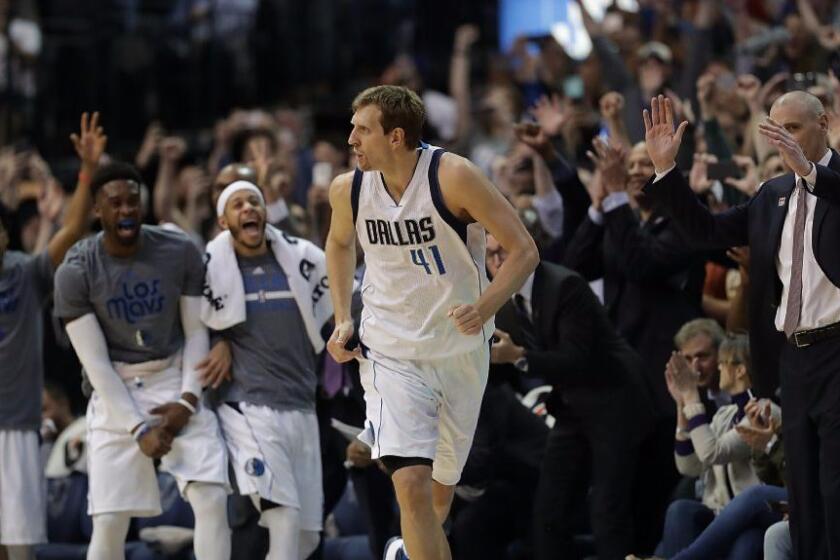 Mavericks forward Dirk Nowitzki (41) runs downcourt after scoring his 30,000th career point in the second quarter against the Lakers on March 7.