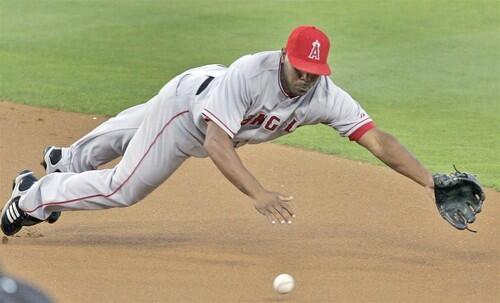 Angels second baseman Howie Kendrick maeks a diving stop to put out Dodgers left fielder Juan Pierre in the first inning Friday night.