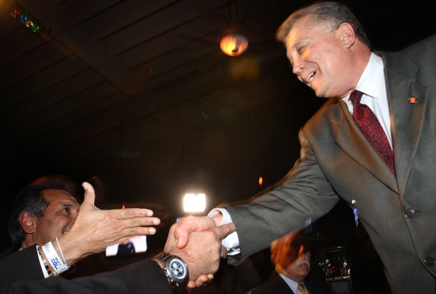Carmen Trutanich shakes hands with supporters at his election-night party at Rocco's Pizza in Studio City.
