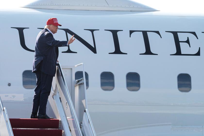 President Donald Trump waves as he boards Air Force One at Joint Base Andrews, Md., Tuesday, July 1, 2025, for a trip to visit a new migrant detention center in Ochopee, Fla. (AP Photo/Cliff Owen)
