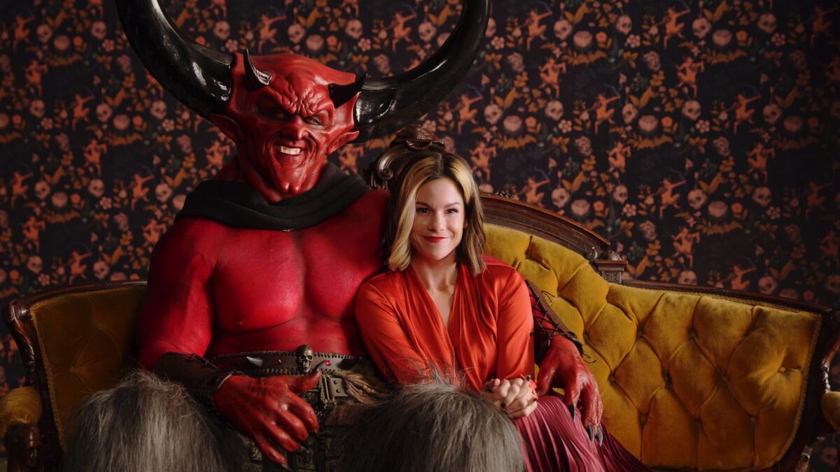 Satan and 2020 cuddle in an ad for Match.