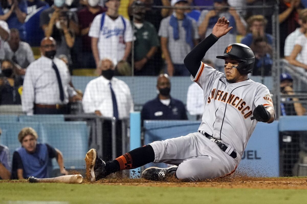 The Giants' Thairo Estrada scores on a single by LaMonte Wade Jr. in the ninth inning Thursday.