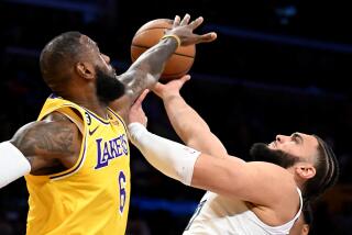 Los Angeles, California April 24, 2023-Lakers LeBron James fouls Grizzlies Davis Roddy in the second quarter at Crypto.com arena Monday. (Wally Skalij/Los Angeles Times)