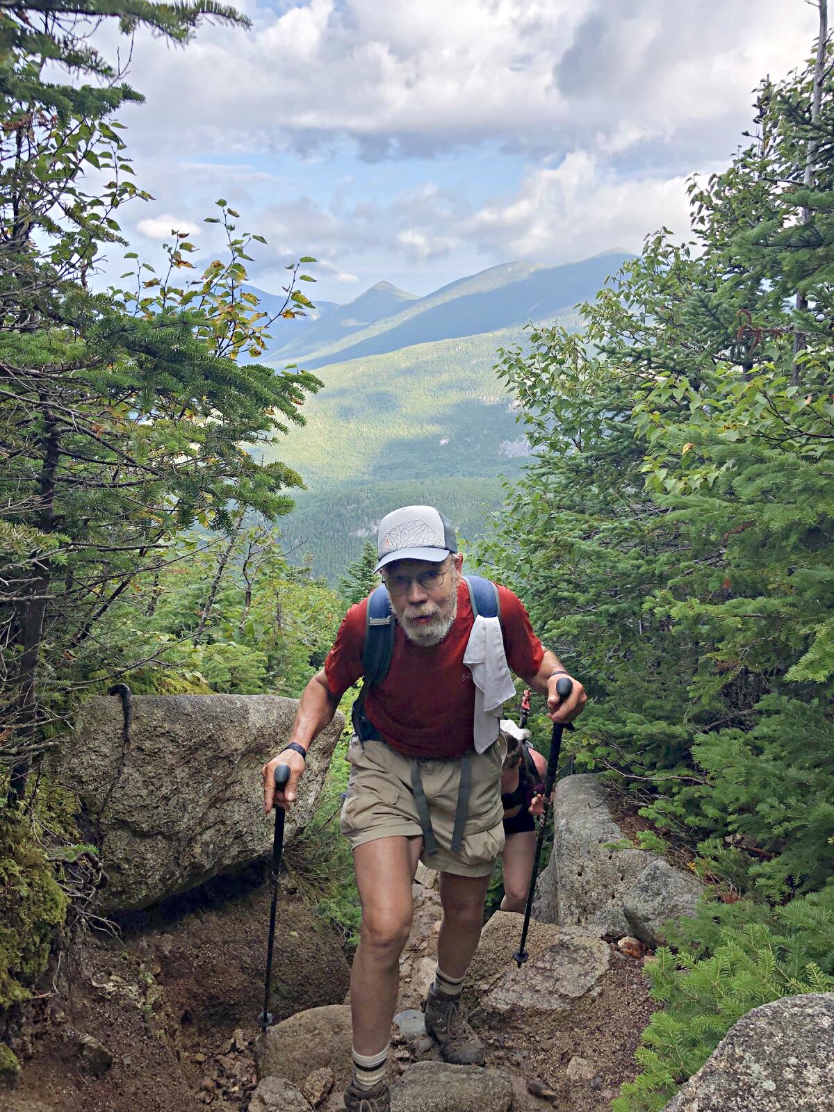 A man hikes up a mountain
