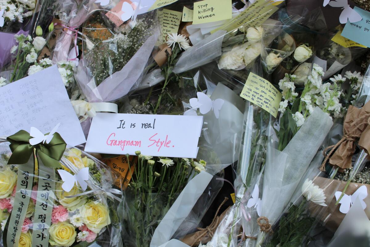 Messages left outside a subway station exit for a young woman who was slain in Seoul.