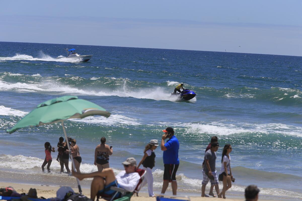 The waters off Huntington Beach were reopened to the public the morning of Saturday July 11, a day after a shark sighting prompted officials to prohibit surfing and swimming for 24 hours.
