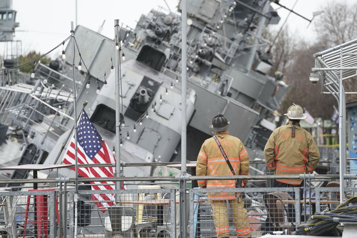 The vintage ship USS The Sullivans is listing to one side after taking on water overnight, Thursday, April 14, 2022 in Buffalo, N.Y. Crews were working to stabilize the decommissioned World War II-era destroyer and keep the 79-year-old vessel from sinking at its berth at the Buffalo and Erie County Naval & Military Park. (Derek Gee/The Buffalo News via AP)