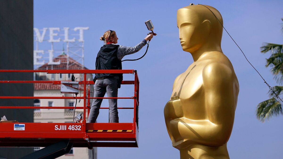 ABC will televise the 89th Academy Awards on Feb. 26 from the Dolby Theatre in Hollywood. Scenic artist Dena D'Angelo sprays gold paint to touch up the Oscar statue in 2015.