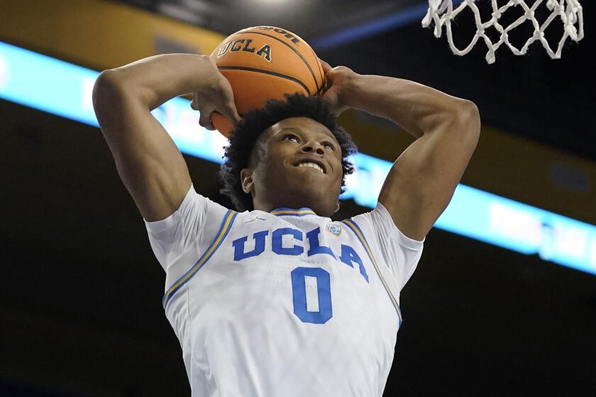UCLA guard Jaylen Clark dunks during the second half of an NCAA college basketball game.