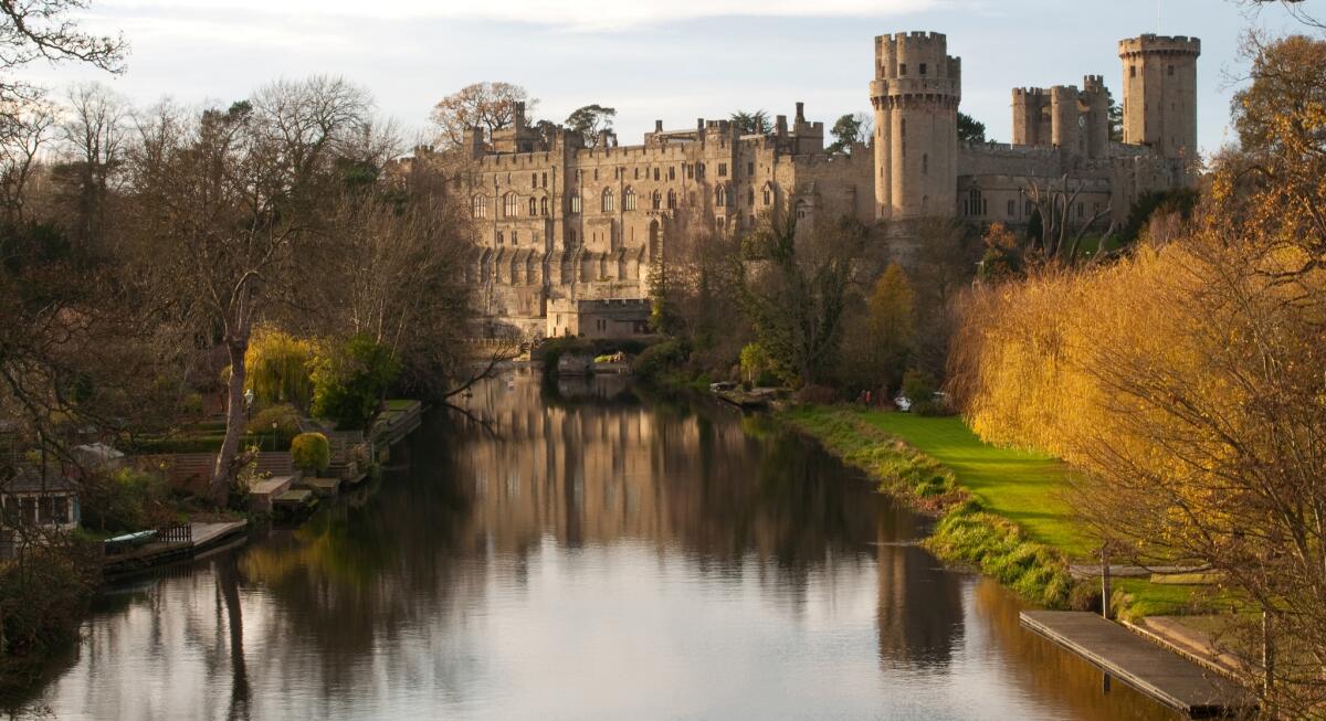 Autumn colours at Warwick castle on the river Avon, England.