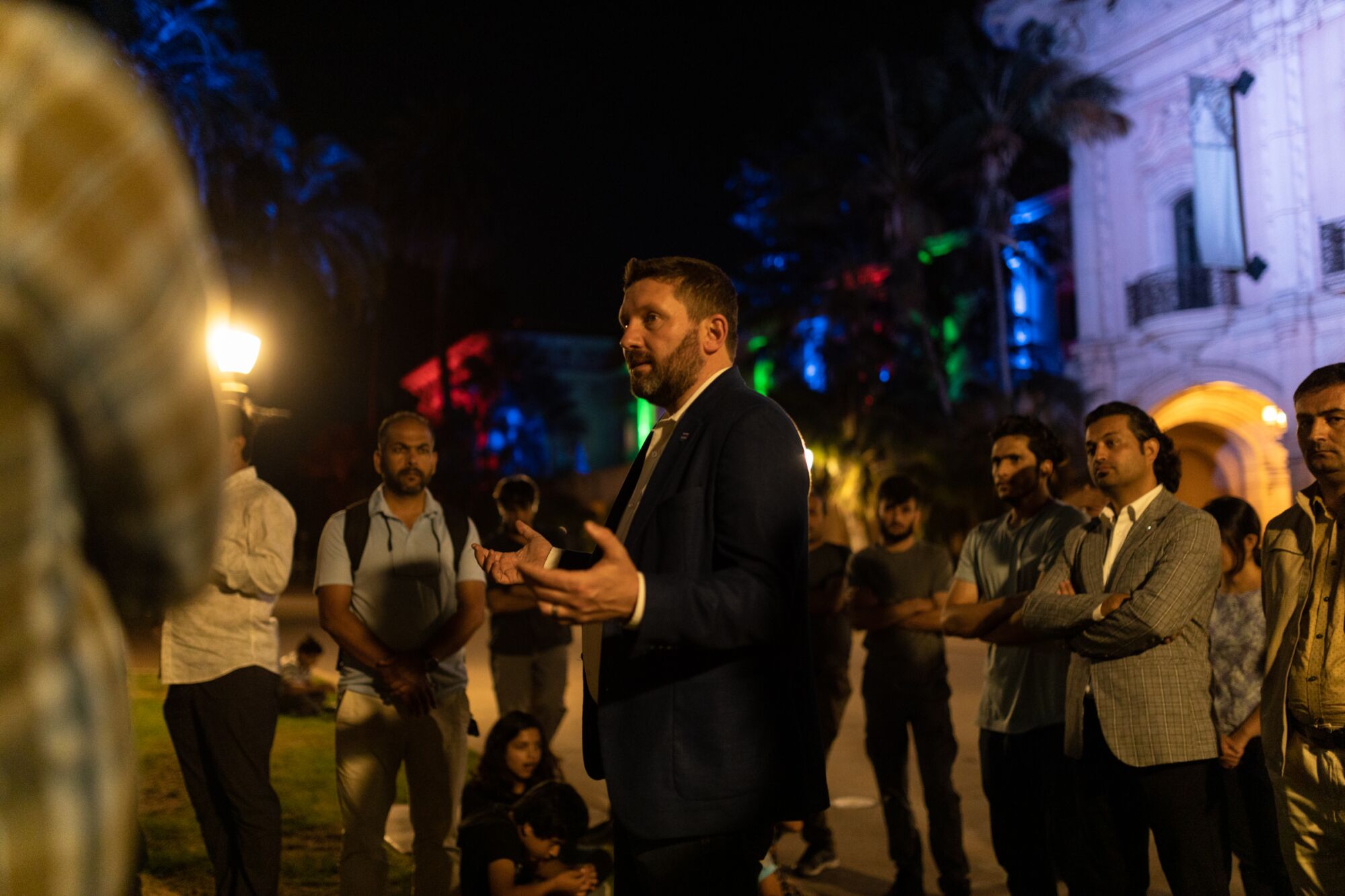 Shawn VanDiver of #AfghanEvac speaks with Afghans in a gathering at Balboa Park