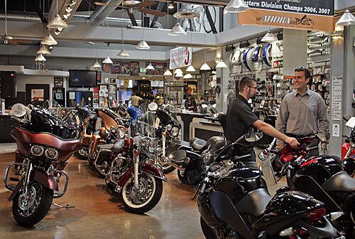 The Harley-Davidson showroom in Glendale. Many dealers are suffering as the economy weakens, credit tightens and transportation, rather than recreation, drives the motorcycle market. Some are selling fuel-efficient, foreign-made scooters on the same floor with Harleys traditional cruisers.