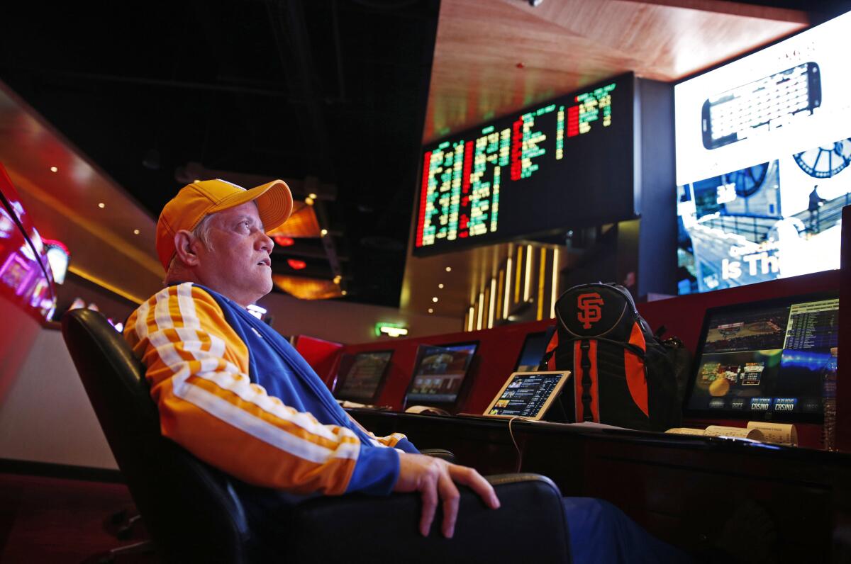 Amado Nanalang watches basketball games while making bets at a sports book in Las Vegas.