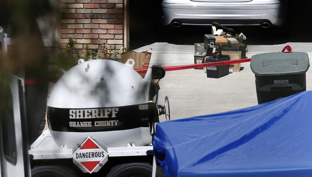 Hazardous explosives sit in the driveway of a home on Fairlane Road in Laguna Niguel, where the Orange County sheriff's bomb squad was sent to evaluate and remove military ordnance found after a domestic disturbance call.