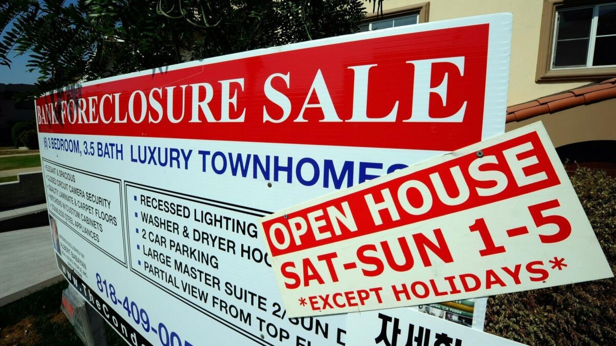 A foreclosure sign is posted in front of town homes in 2010 in Los Angeles. In 2012, Gov. Jerry Brown and the Legislature took $410 million that was supposed to assist victims of abusive mortgage lending and used it to help balance the state budget.