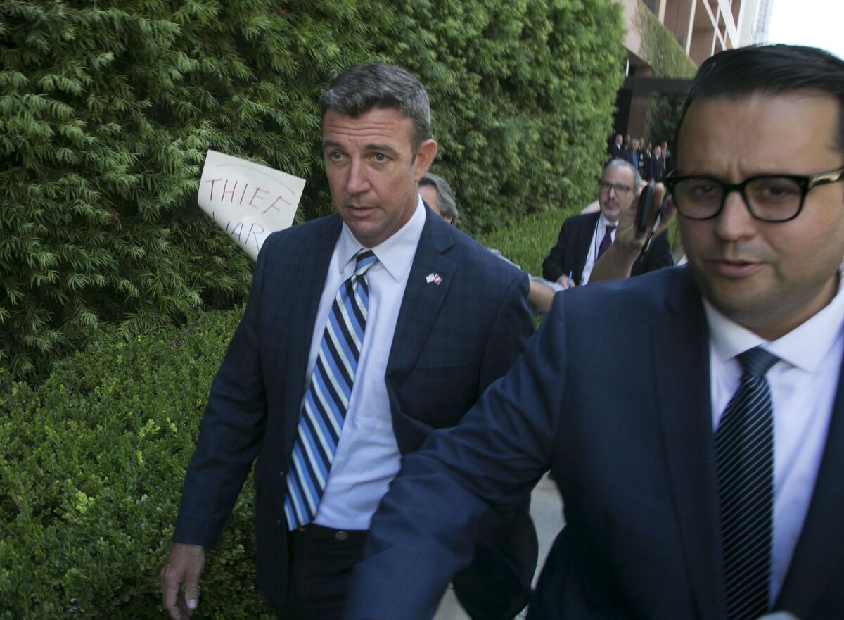 Duncan D. Hunter, left, departs the Federal courthouse in San Diego after he pleaded not guilty to charges that he and his wife Margaret Hunter misused $250,000 in campaign contributions. Margaret Hunter has since pleaded guilty to a conspiracy charge.