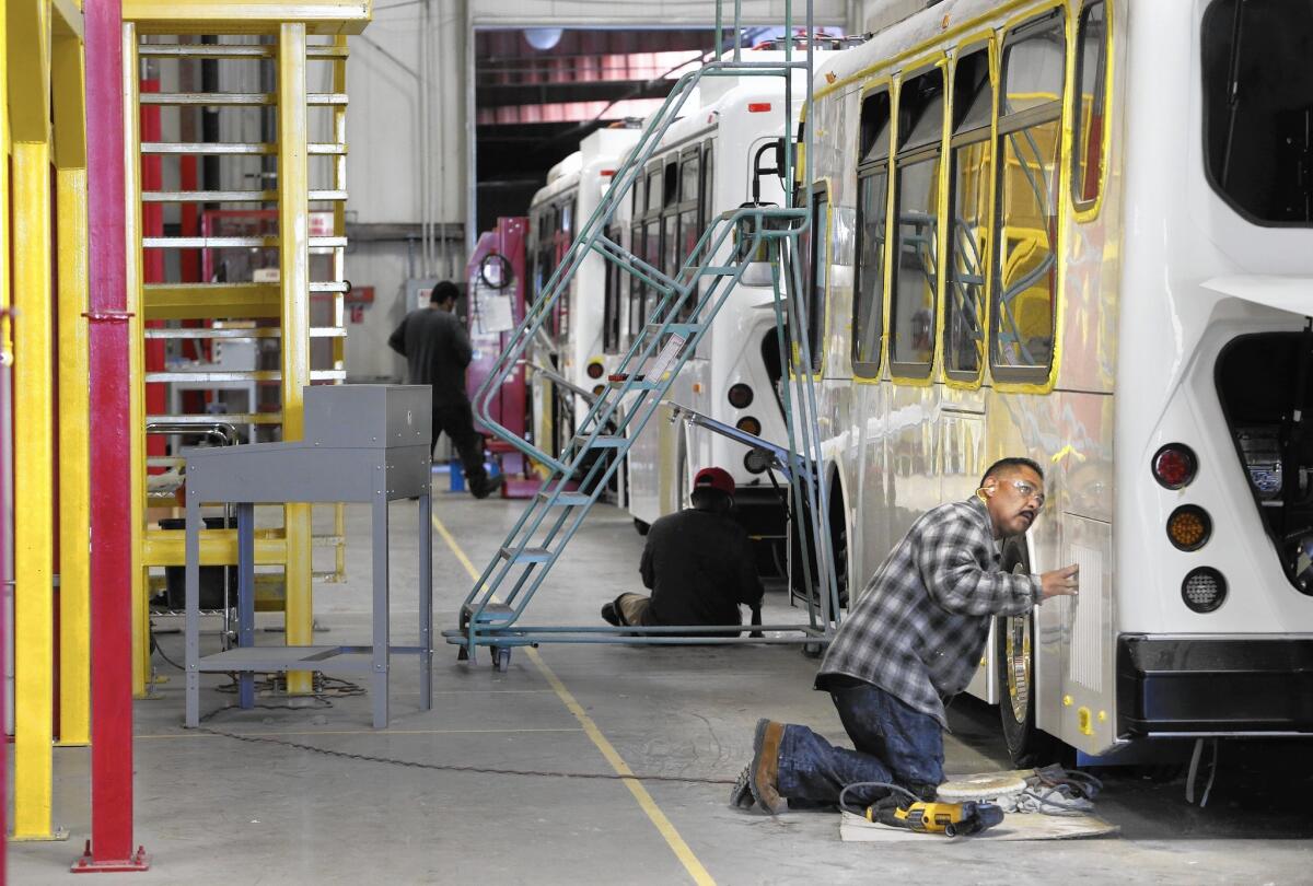 An electric coach is near completion at Build Your Dreams' factory in Lancaster. The Chinese firm says it has an exemption from L.A.'s living wage rules.