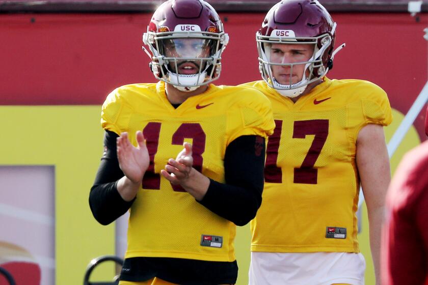 LOS ANGELES, CALIF. - MAR. 8, 2023. USC Trojans quarterbacks Caleb Williams, left, and Jake Jensen warm up during a spring practice session at Howard Jones Field on Wednesday, Mar. 8, 2023. (Luis Sinco / Los Angeles Times)