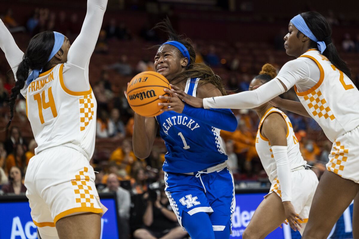 Kentucky's Robyn Benton (1) drives to the basket against the defense of Tennessee's Jasmine Franklin (14) and Rickea Jackson (2) in the second half of an NCAA college basketball game during the Southeastern Conference women's tournament in Greenville, S.C., Friday, March 3, 2023. (AP Photo/Mic Smith)