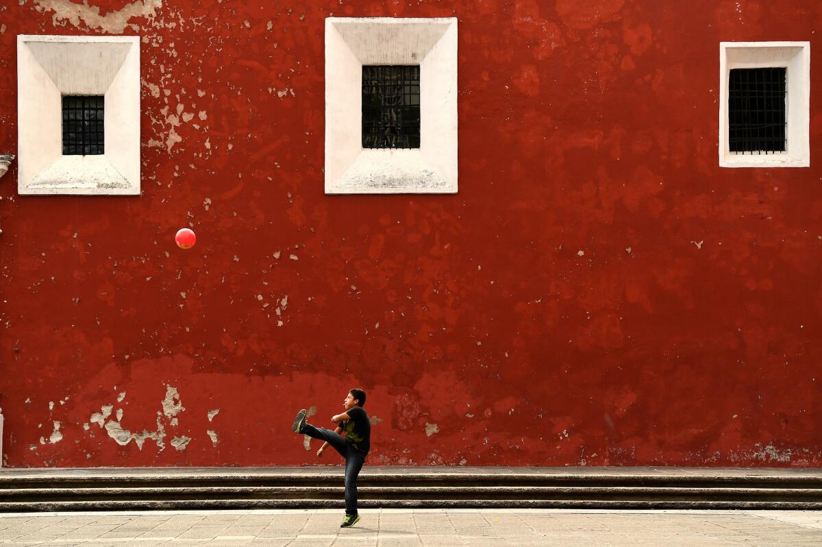 A boy plays soccer outside the Covento de Santo Domingo in Puebla, Mexico.