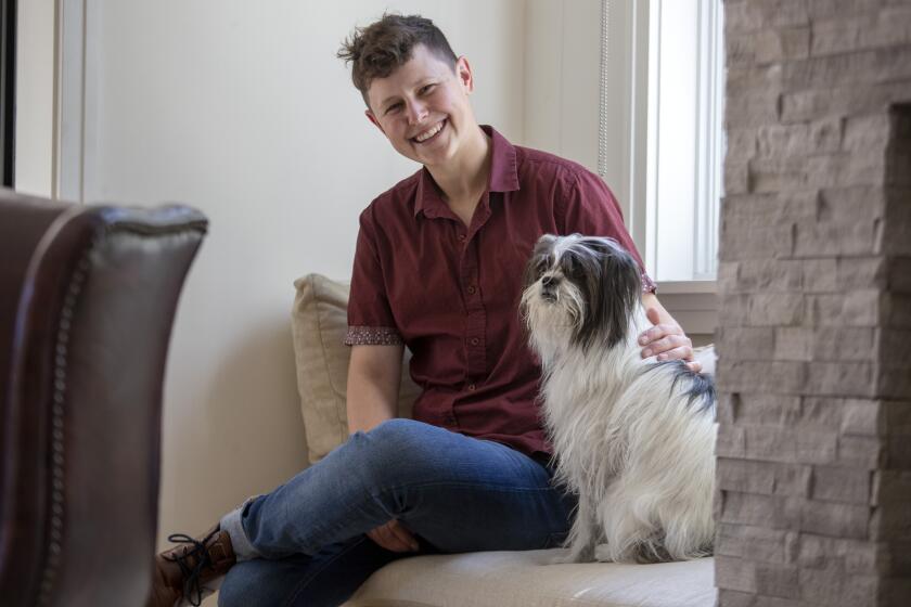 Studio City, California - April 08: Charlee Corra sits for portraits at home with dog Roxee on Friday, April 8, 2022 in Studio City, California. (Brian van der Brug / Los Angeles Times)