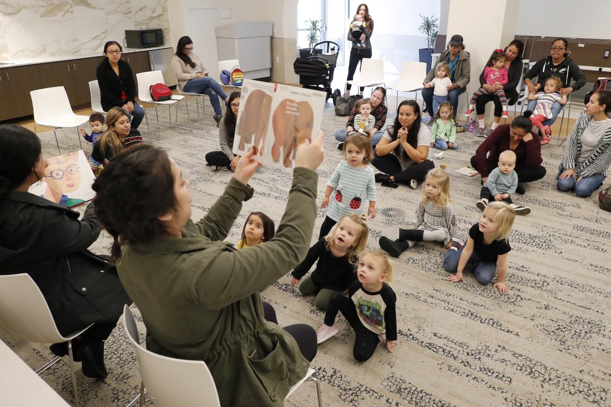 Staff members read stories in English and Spanish during Bilingual Storytime at the Donald Dungan Library in Costa Mesa in January. The Dungan Library and all other branches in the OC Public Libraries system are closing for the rest of March in response to the coronavirus.