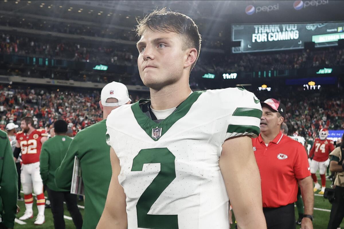Jets quarterback Zach Wilson walks off the field after playing against the Kansas City Chiefs.