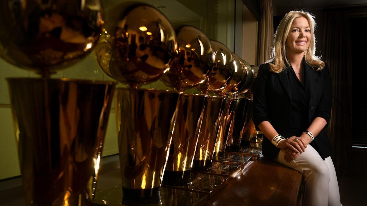 Lakers owner Jeanie Buss sits next to the team's championship trophies in her El Segundo office in 2016.
