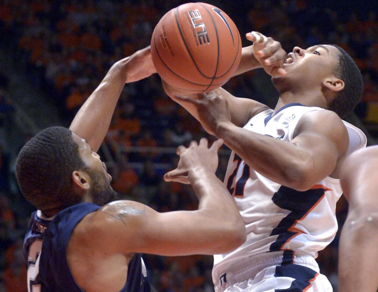 Illinois' guard Malcolm Hill goes up against Penn State's guard D.J. Newbill during the first half.