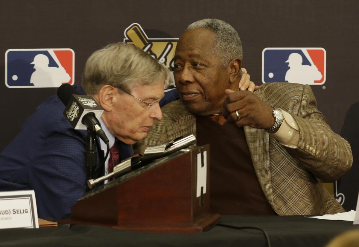 Major League Baseball Commissioner Bud Selig, left, greets Hank Aaron.