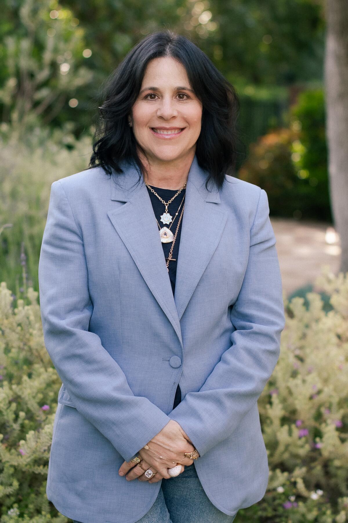 Janet Heller, a Calabasas-based jeweler, smiles at the camera as she poses for portrait 