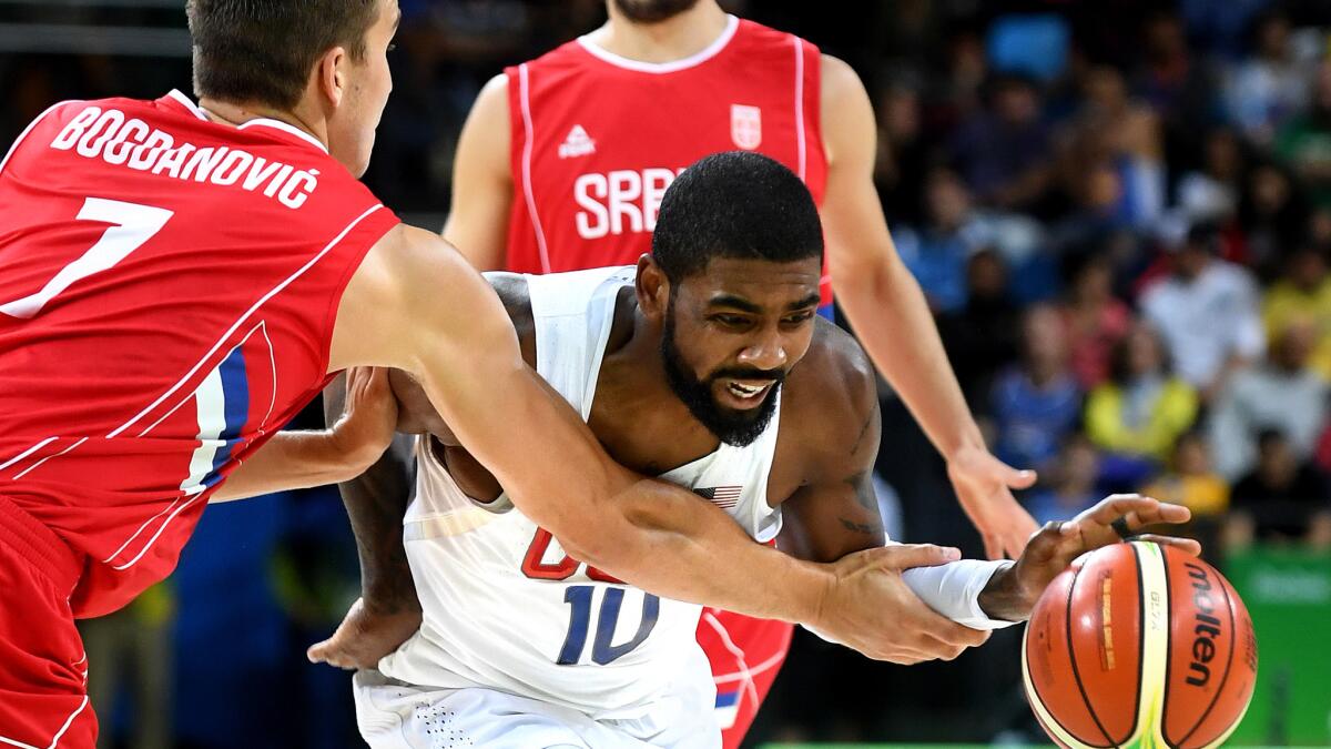 U.S. guard Kyrie Irving tries to drive past Serbia's Bogdan Bogdanovic during their preliminary round game Friday.