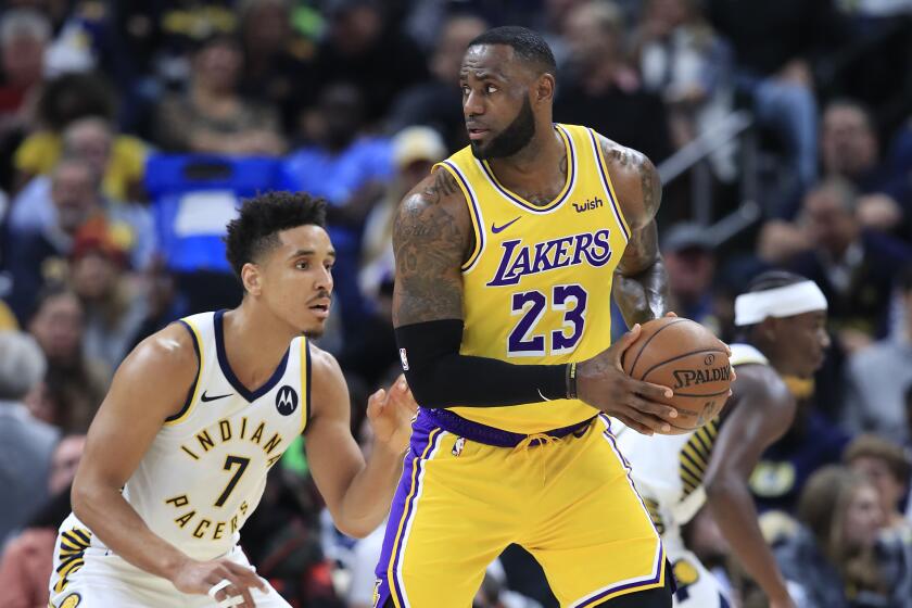 Lakers forward LeBron James is defended by Pacers guard Malcolm Brogdon during a game Dec. 17, 2019, at Indianapolis.