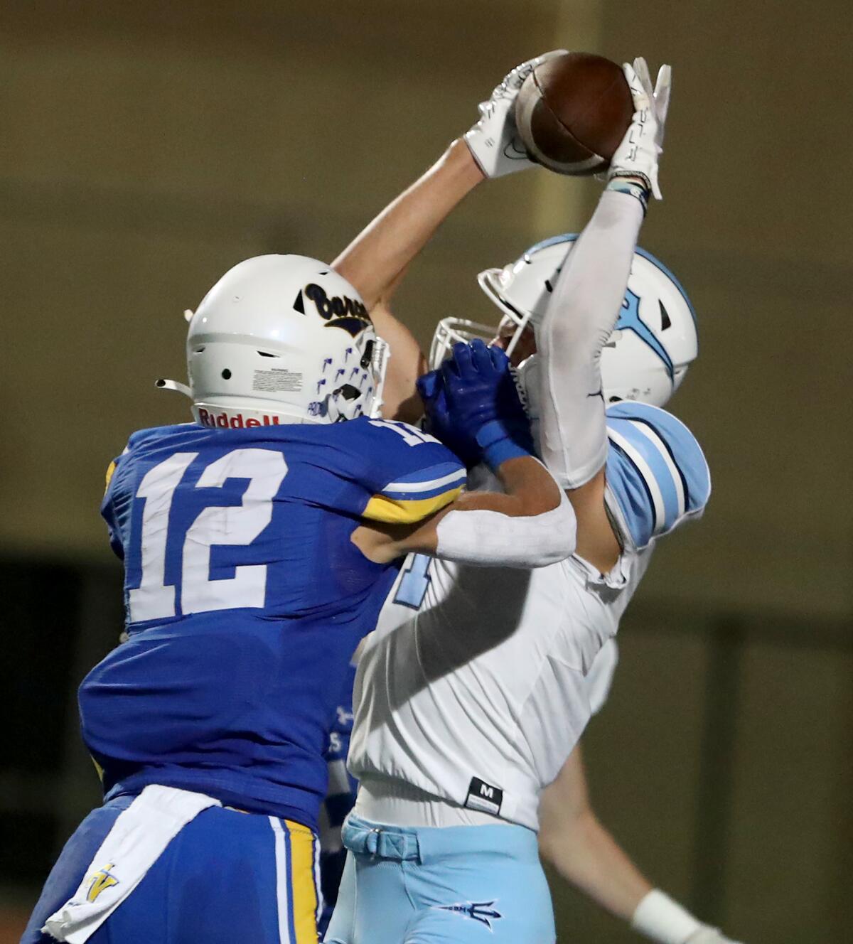 Corona del Mar's Cooper Hoch (1) makes a catch over a defender in the end zone during a Sunset League opener on Thursday.