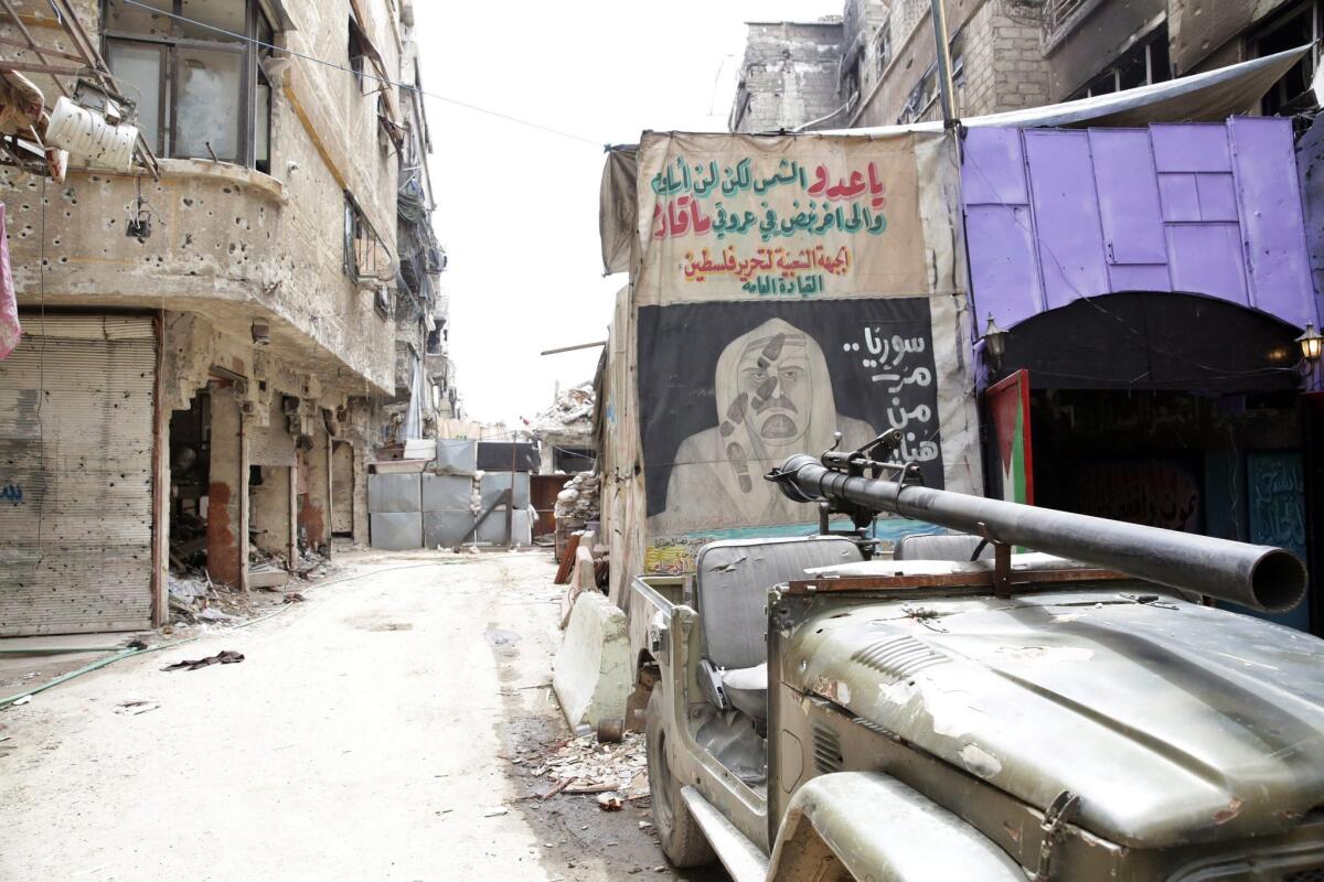 Graffiti is seen on a wall at the entrance to the Palestinian Yarmouk refugee camp south of Damascus on April 9.