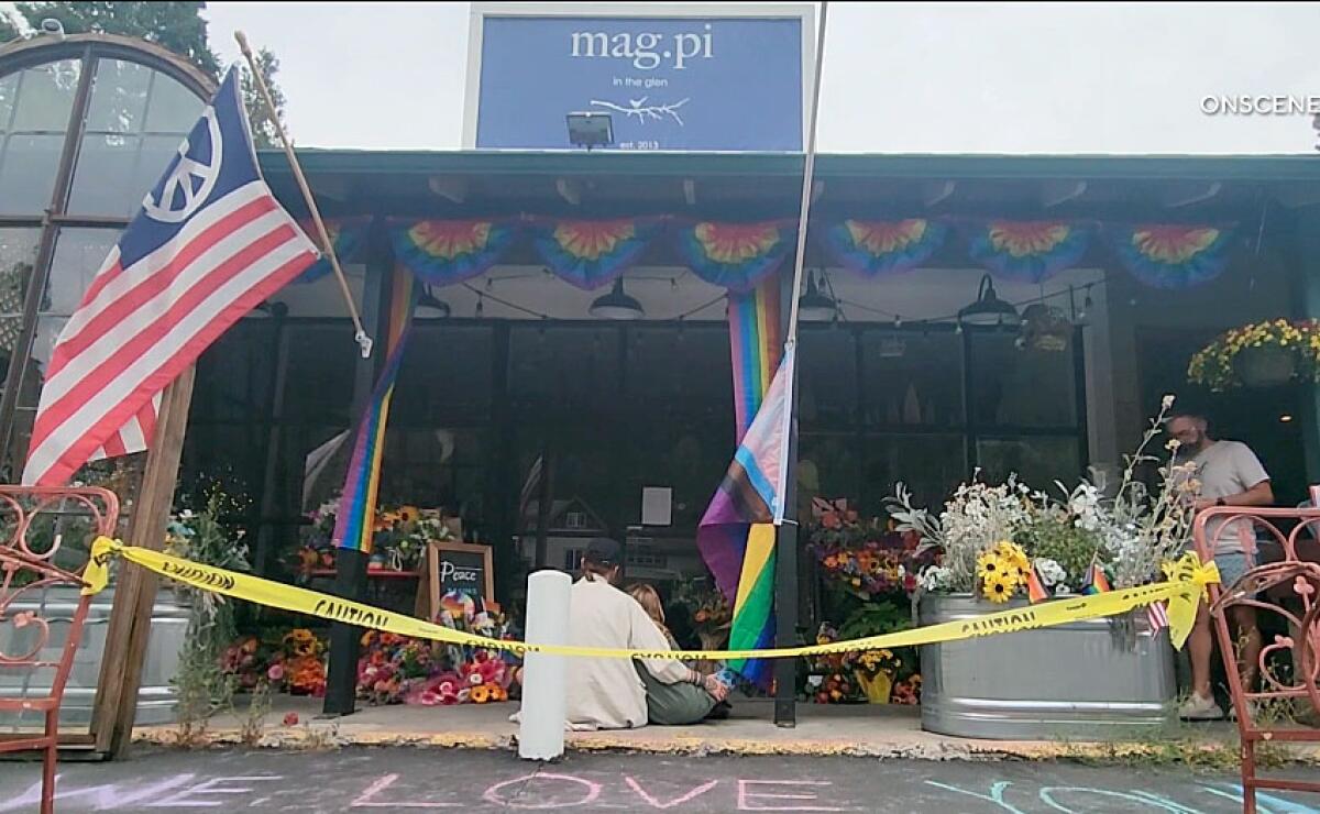 People gathered and brought flowers, flags and banners at the Mag.pi store in Cedar Glen, in San Bernardino County.