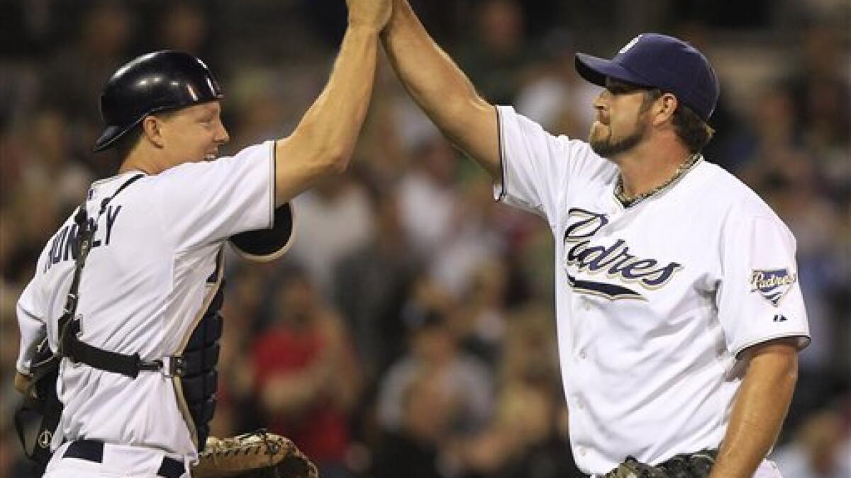 San Diego Padres pitcher Heath Bell, left, looks to the outfield